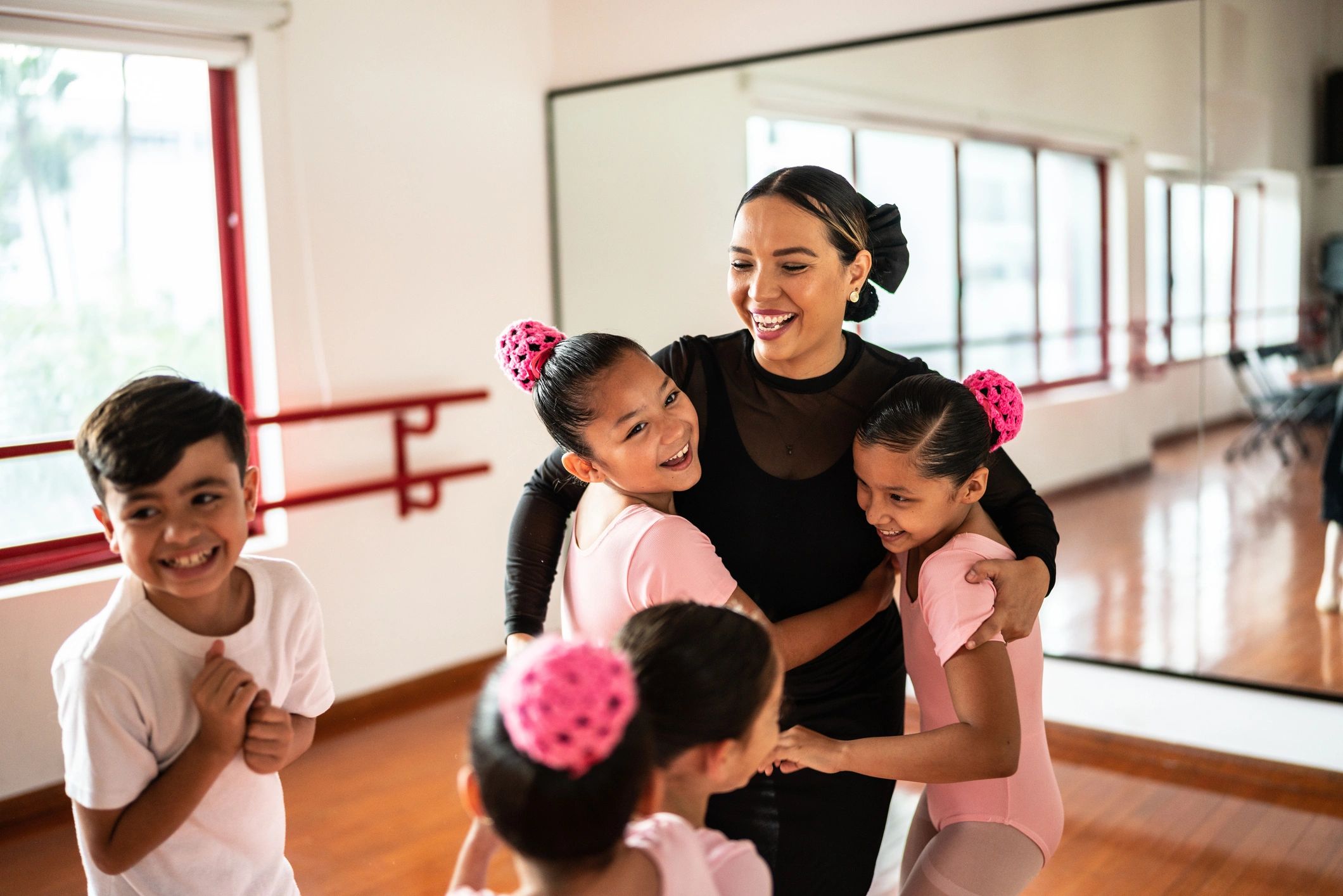 Parent with dance teacher in a warm studio setting