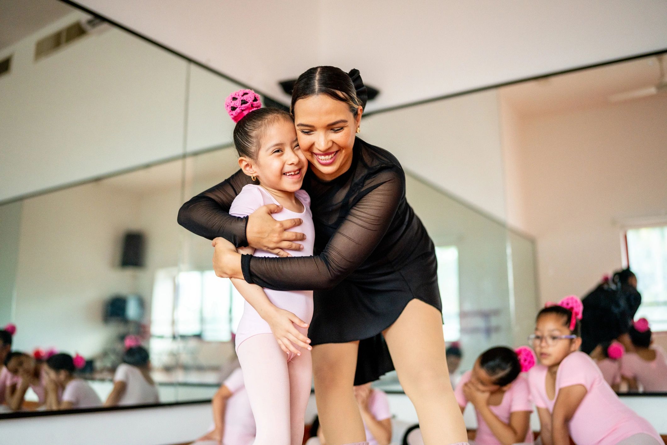 Smiling parent with child at a dance studio