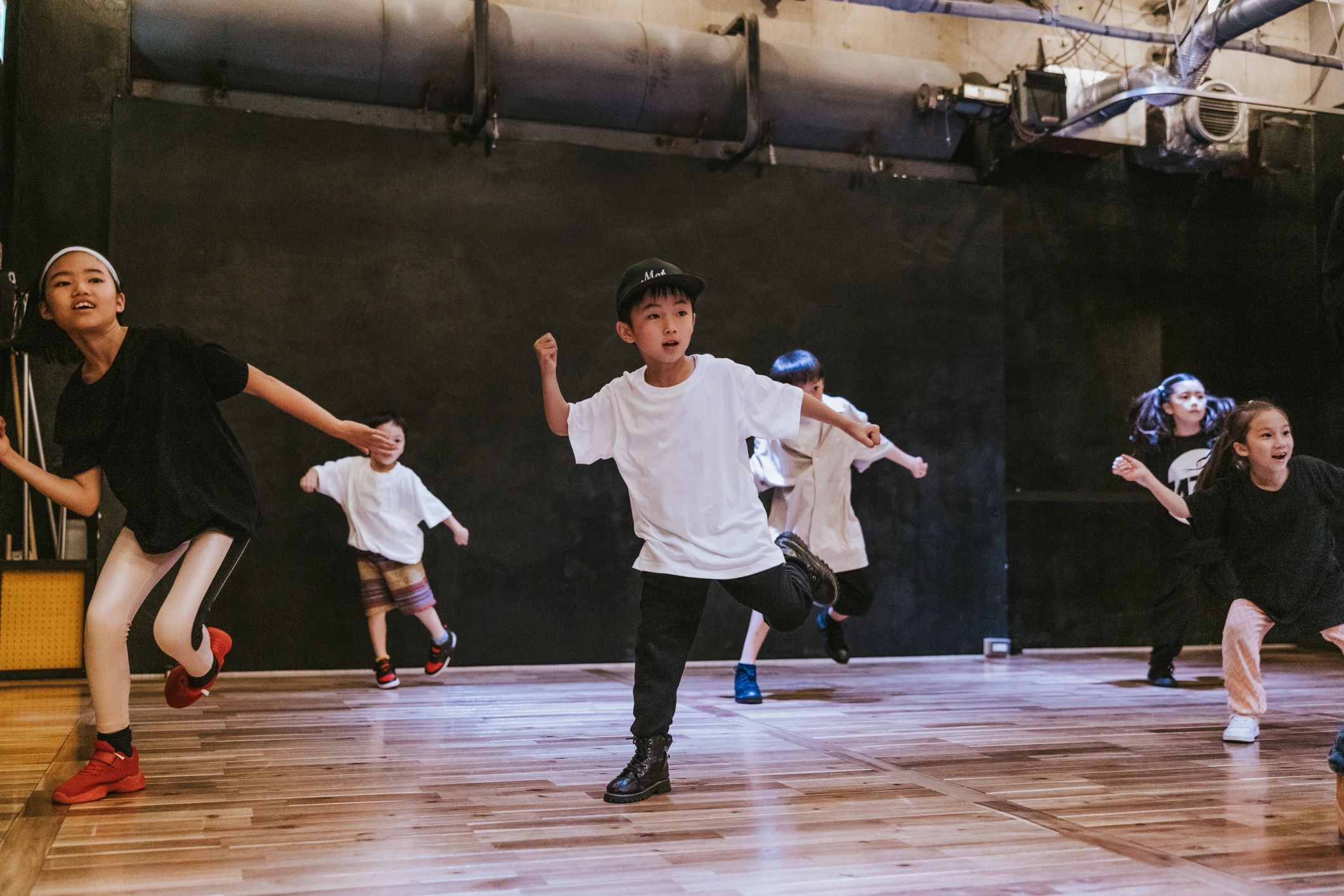 Students participating in a dance class at a studio